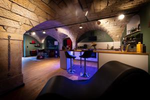 a bar in a room with a stone wall at Liebesgewölbe in Pirna