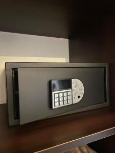 a microwave oven with a remote control on a shelf at Hotel Manso de Velasco in San Fernando