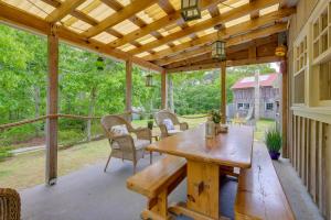 a screened in porch with a wooden table and chairs at Yard and Fire Pit Unique Cape Cod Home in Brewster in Brewster