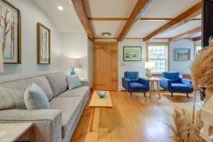 a living room with a couch and two blue chairs at Unique Cape Cod Vacation Rental with Yard and Fire Pit in Brewster