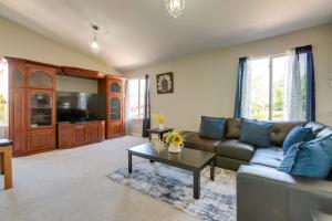 a living room with a couch and a table at Spacious Aurora Home 20 Mi to Downtown Denver! in Aurora
