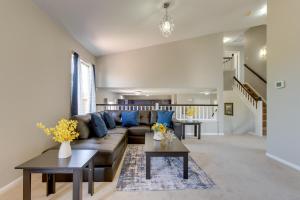 a living room with a couch and two tables at Spacious Aurora Home 20 Mi to Downtown Denver! in Aurora