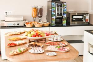 a table filled with different types of food at HOTEL NARCEA in Santa Pola
