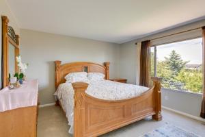 a bedroom with a wooden bed and a window at Spacious Aurora Home 20 Mi to Downtown Denver! in Aurora