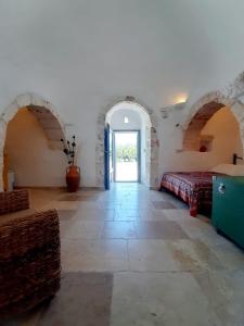 a large room with two beds and a window at Trullo Tranquillo Ostuni in Ostuni
