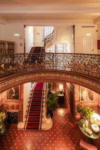 an ornate staircase in a building with a stair case at Hospes Infante Sagres Porto in Porto