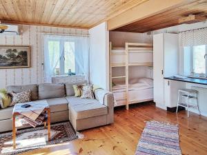 a living room with a couch and a bunk bed at Holiday home LJUSDAL IV in Ljusdal