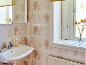 La salle de bains est pourvue d'un lavabo et d'une fenêtre. dans l'établissement Holiday home LJUSDAL IV, à Ljusdal