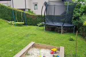 a garden with a swing and a trampoline at Apartma pri babici in Slovenj Gradec