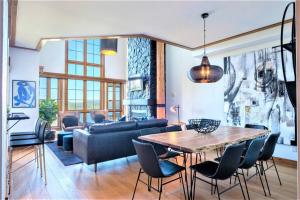 sala de estar con mesa y sofá en Équinoxe 164-2 / Exclusive Mountain Home With View, en Mont-Tremblant