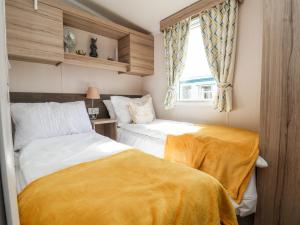 a bedroom with two beds and a window at ABCVan in Abergele