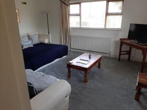 a living room with a couch and a coffee table at The Fold - 5 mins to Lytham St Annes - Ribby Hall Village 