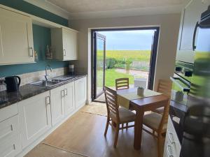 a kitchen with a table and chairs and a window at The Fold - 5 mins to Lytham St Annes - Ribby Hall Village 