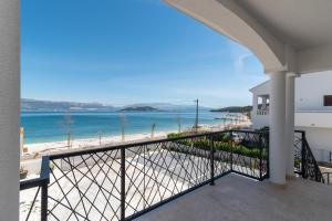 a balcony with a view of the beach at Beachfront Apartment with parking in Slatine