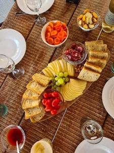 a wooden table topped with plates and bowls of food at Holiday home Smokvin Hlad in Peroj