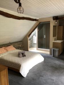 a bedroom with a bed and a large window at Le Domaine de la Claire Fontaine gites & chambres d'hôtes avec spas privatifs in Montvalent