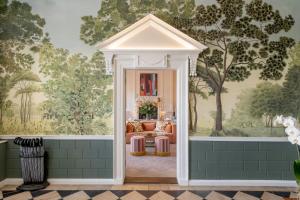 a living room with a sofa and a wall mural at The Royal Crescent Hotel & Spa in Bath