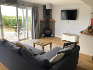 a living room with a couch and a fireplace at Seaview bungalow in Hornsea