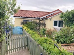 a house with a fence in front of it at Seaview bungalow in Hornsea