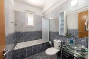 a bathroom with a toilet and a sink and a tub at Protaras Sunrise Zen Seafront Villa in Protaras +38 photos