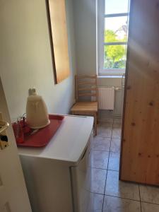 a kitchen with a table with a yellow appliance on it at Willa Westa in Mielno