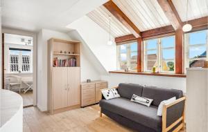 sala de estar con sofá y algunas ventanas en Cozy Home In Skagen With Kitchen, en Skagen