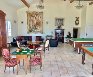 a living room with a pool table at Domaine du cheval d’argent 