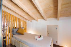 a bed in a room with wooden ceilings at Blue sky loft by Corfuescapes in Spartýlas