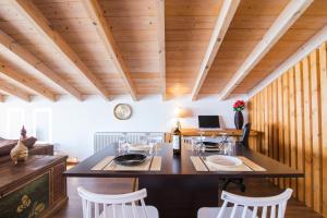 a kitchen with a large island in a room with wooden ceilings at Blue sky loft by Corfuescapes in Spartýlas