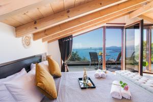 a living room with a bed with a view of the ocean at Blue sky loft by Corfuescapes in Spartýlas