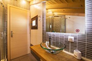 a bathroom with a glass bowl sink on a counter at Blue sky loft by Corfuescapes in Spartýlas +25 photos