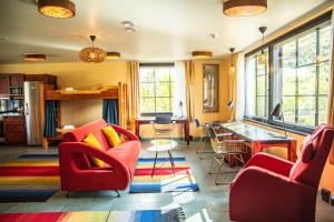 a living room with red chairs and a table at Utsjoki Arctic Resort in Utsjoki
