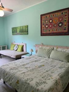 a bedroom with two beds and a rug on the wall at Ai Cinque Campanili in Finale Ligure