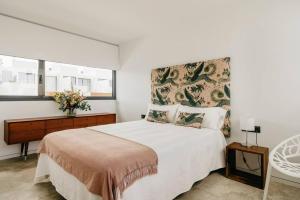 a white bedroom with a large bed and a window at Armonía en el Paraíso - 8 pax in Zahara de los Atunes +8 photos