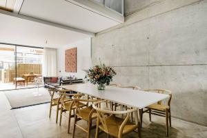 a dining room with a white table and chairs at Armonía en el Paraíso - 8 pax in Zahara de los Atunes