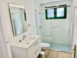 a bathroom with a sink and a toilet and a shower at Famara Frontsea house in Famara