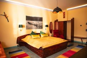 a bedroom with a large bed and a chair at Utsjoki Arctic Resort in Utsjoki