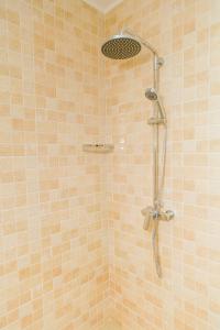 a shower with a shower head in a bathroom at Jonc d'Or Villa Self Catering in La Digue