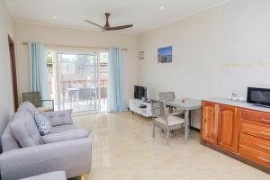 a living room with a couch and a table at Jonc d'Or Villa Self Catering in La Digue