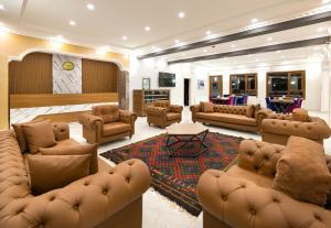 a large living room with couches and a tv at Avulot Mountain Resort Hotel in Trabzon