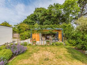 a home with a garden and a house at Pass the Keys Charming Bosham Garden Lodge in Chichester