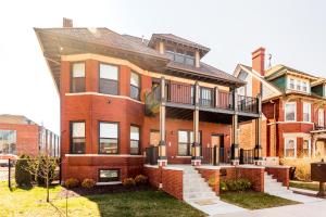 a brick house with a balcony on top of it at Mint House Detroit - Brush Park in Detroit