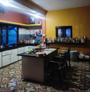 a kitchen with a large island in a room at Shree Om Nanda Rudra Hotel Chaukori Pithoragarh in Chaukori