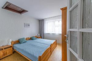 a bedroom with a bed and a window and a door at Gościniec na Leśnej in Sztutowo