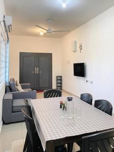 a living room with a table and chairs and a couch at A Cool place to stay in Seremban