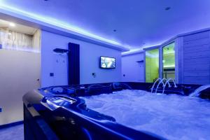 a jacuzzi tub in a large room with at VIP Villa & Spa in Colibiţa +49 photos