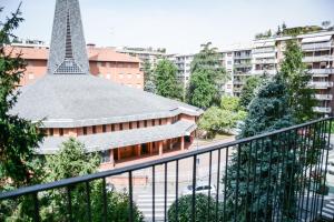 a view of a building with a tower in the background at Mysa Properties - Ampio monolocale in zona Bande Nere in Milan