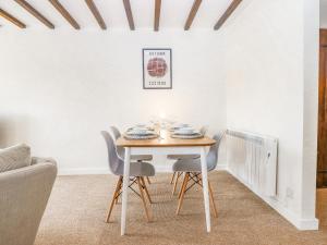a dining room with a table and chairs at Rose Cottage at Treaslake Farm in Honiton
