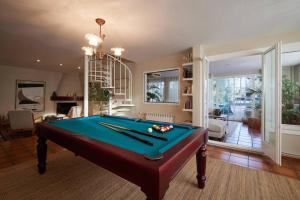 a pool table in a living room with a pool at Torre Lolita - House in Lleida for 8 with pool and tennis court in Lleida