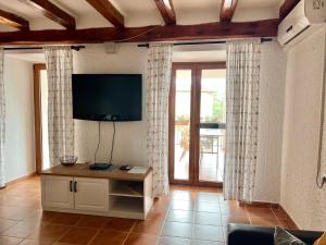 a living room with a flat screen tv on the wall at Apartment Anamarija in Poreč